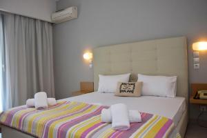 a bedroom with a large bed with towels on it at Alonaki Beach in Preveza
