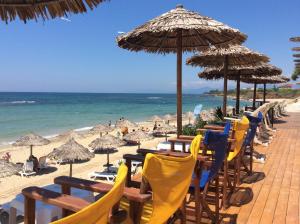 a row of chairs and umbrellas on a beach at Alonaki Beach in Preveza +25 photos