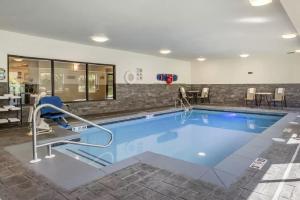 a large swimming pool with a chair in a room at Comfort Inn La Porte in LaPorte