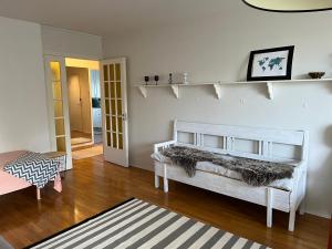 a living room with a bed and a wooden floor at Apartment Puistokatu in Kokkola