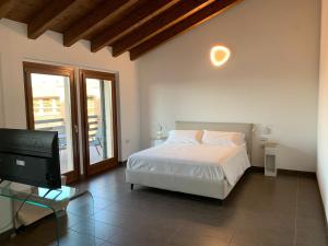 a bedroom with a bed and a flat screen tv at Bes Residence Bergamo Polaresco in Bergamo