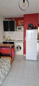 a kitchen with a bed and a refrigerator in it at la crique in Collioure
