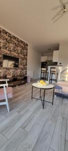 a living room with a table in the middle of a room at Apartament Madelain in Jelenia Góra