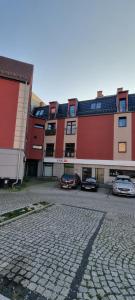 a group of buildings with cars parked in a parking lot at Apartament Madelain in Jelenia Góra