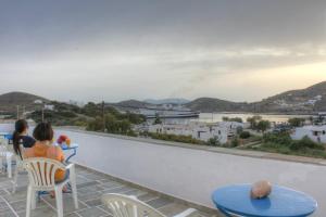 a view from the balcony of a hotel with tables and chairs at Violetta in Ios Chora