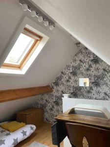 a attic room with a sink and a window at The Hideaway at Peacock Farm in Bottesford