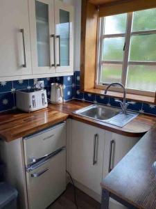 a kitchen with a sink and a counter top at The Hideaway at Peacock Farm in Bottesford