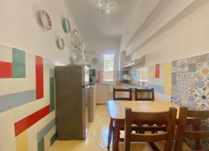 a kitchen with a table and chairs and a refrigerator at CasaViva - Family Home in Santa with AC in Santa Margherita Ligure