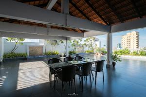 a patio with a table and chairs on a balcony at E&V Apartment in Phnom Penh