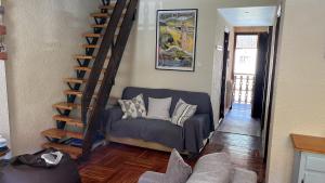 潘蒂科薩的住宿－Casa Tere Panticosa，带沙发和螺旋楼梯的客厅