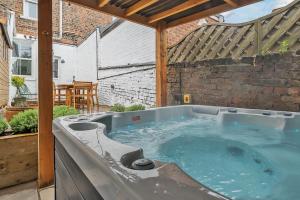 a hot tub in the backyard of a house at The Little Domus - modern YORK home with HOT TUB in York