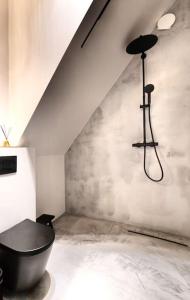 a bathroom with a black bath tub in a room at Modern Villa By The Sea in Palanga +23 photos