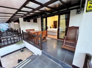 a balcony of a house with a table and chairs at Baan Pranai In Pai in Pai +23 photos