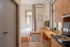 a kitchen with a bed and a sink in a room at Brassbell studios in Zamalek in Cairo