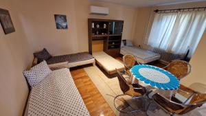 a living room with a table and chairs at Friendly Apartment in the suburb. in Budapest