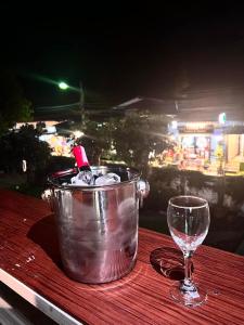 a bucket and a wine glass on a table at Baan Pranai In Pai in Pai +30 photos