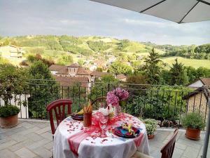 a table with flowers on top of a balcony at Holiday home Ca' del Cinema in Mombercelli