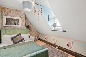 a bedroom with a green bed and a staircase at Luxe Coastal Retreat w/ Hot Tub in Ramsgate