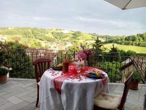 a table with a red and white table cloth on a patio at Holiday home Ca' del Cinema in Mombercelli