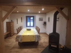 a dining room with a yellow table and chairs at La Chaumière in Les Contamines-Montjoie