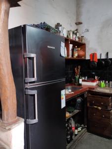 cocina con nevera negra en Motoposada Campera Negra en San Salvador de Jujuy