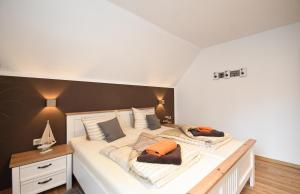 a bedroom with a large bed with two pillows at Ferienwohnung Weitblick mit Logia in Lobbe