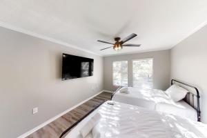 a bedroom with a bed and a ceiling fan at Willow Haven in Tampa