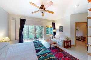 a bedroom with a bed and a ceiling fan at Fawn Voyage in Portola