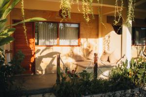 a house with a couch in front of a door at Mango Lodge in Selong Belanak