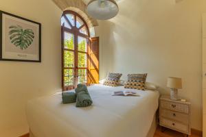 a bedroom with a white bed with a window at Charming 2 Bedroom Apartment at Sevilla City Center By Cityzen in Seville