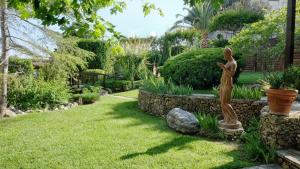 a statue of a woman in a garden at B&B Le Rose in Siderno Marina