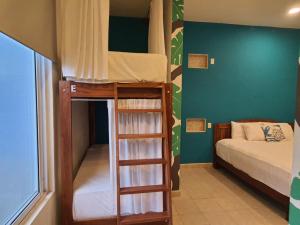 a room with two bunk beds and a bed at Hotel La Palmita by MIJ in Tulum