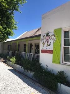 a building with a sign on the side of it at Greyton Toad Hall in Greyton