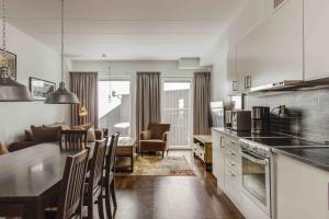 a kitchen and living room with a table and chairs at Funäs Ski Lodge in Funäsdalen