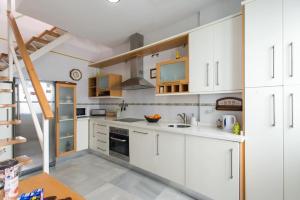 a kitchen with white cabinets and a sink at Apt. Sierpes-Cuna, wifi, HVAC (VFT/SE/00239) in Seville