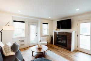 a living room with a couch and a fireplace at Modern 3BR in the Heart of Ballard in Seattle