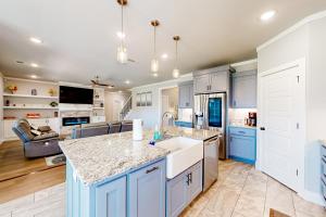 a kitchen with blue cabinets and a counter top at Life is Good on 18th Street in Bentonville