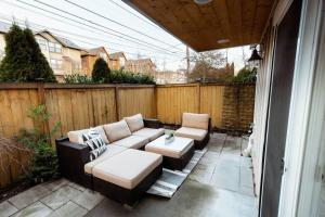 a patio with a couch and two chairs and a table at Modern 3BR in the Heart of Ballard in Seattle