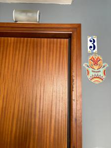 a wooden door with a sign on top of it at Sweet Sedassos in Tarragona