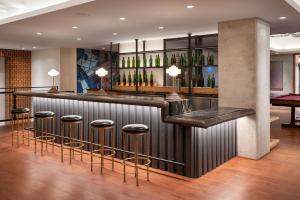 a bar with stools in a room with wine bottles at SoMa 1br w rooftop bbq concierge nr Bart SFO-1431 in San Francisco