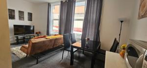 a living room with a couch and a window at City Blessed Aptm 5 with free parking in South Shields