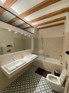 a bathroom with two sinks and a toilet and a tub at Private room By BCN Center in Barcelona