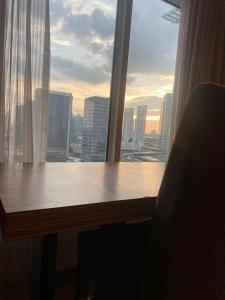 a window with a view of a city skyline at KL Dua Sentral Dreamy Stay Studio in Kuala Lumpur