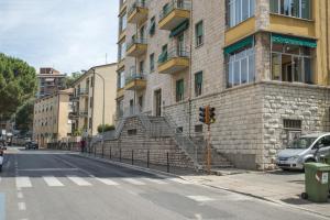 a brick building with stairs on the side of a street at B&B dei Filosofi Bed and Breakfast in Perugia