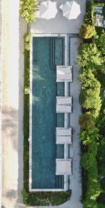 an overhead view of a swimming pool and a house at Mango Lodge in Selong Belanak