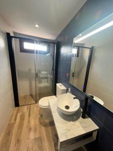 a bathroom with a toilet and a sink and a shower at El Brollador in Corbera +28 photos