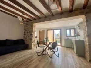 a living room with a table and chairs at El Brollador in Corbera