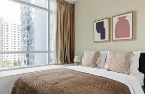 a bedroom with a bed and a large window at Comfortable 1Bedroom 1Bath apartment in Singapore! in Singapore