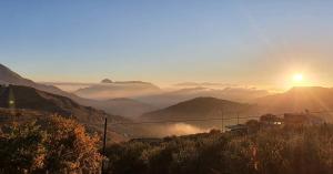 a view of a valley with the sun rising over mountains at Villa Paola appartamento completo in Ciminna