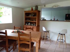 a kitchen and dining room with a wooden table and chairs at Nature in Fort-de-France